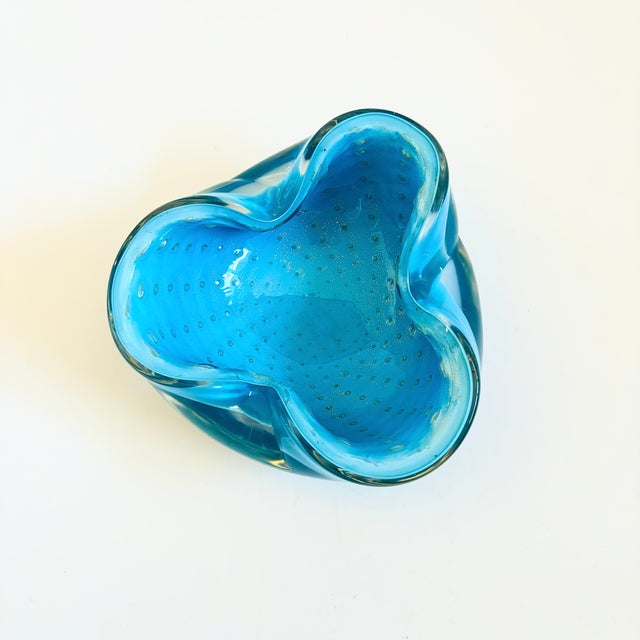 A vintage mid century art glass bowl from Murano, Italy by Alfredo Barbini. Made of thick heavy glass in a vibrant blue...