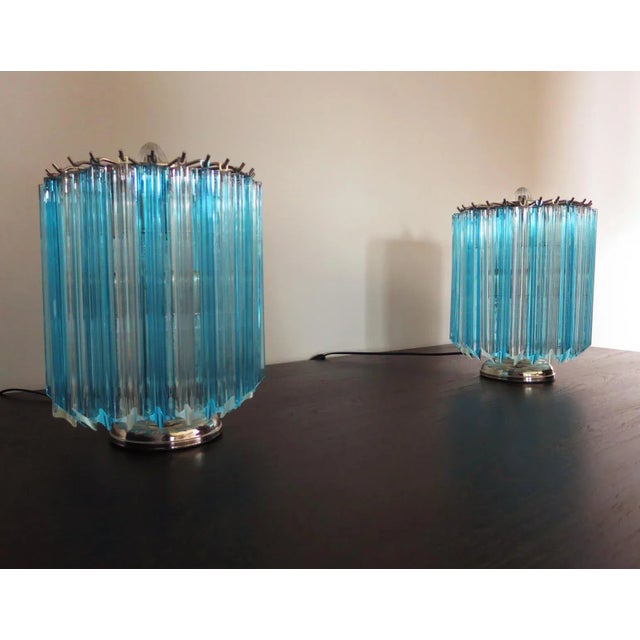 This magnificent pair of table lamps features 24 transparent and clear blue prism quadriedri each. The glasses are 11...