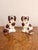 Pair of antique Staffordshire dogs, having a pair of seated spaniels with white and brown coloured coats and matching...