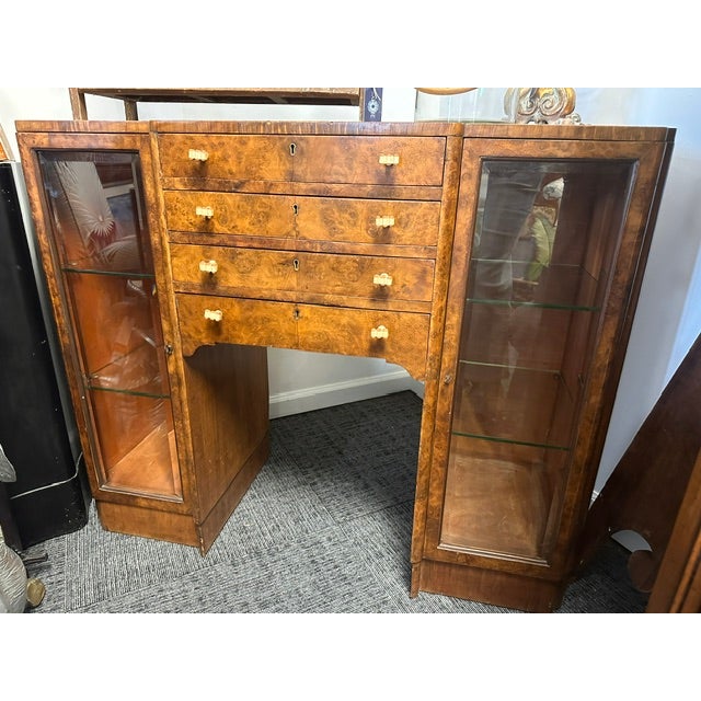 An exceptional and highly unique 1930s Art Deco burlwood veneer silver storage canteen. It features a central stack of...