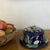 Antique lidded butter dish made in England by Forester, The cobalt background is overlayed with relief molded water...