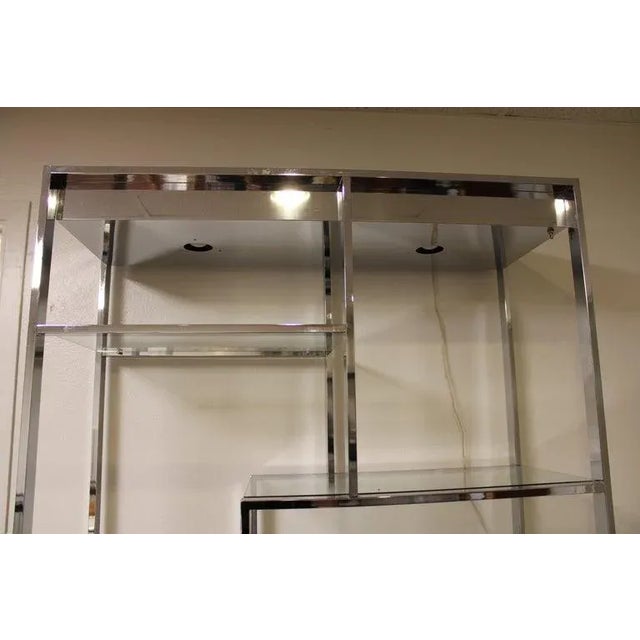 Design Institute of America (DIA) chrome plated steel Etagere with new tempered glass shelves. Etagere has label which is...