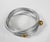 Late 20th century aluminum wire wrap bracelet with gold color balls. Some small spots of oxidation, inside width 2.5".