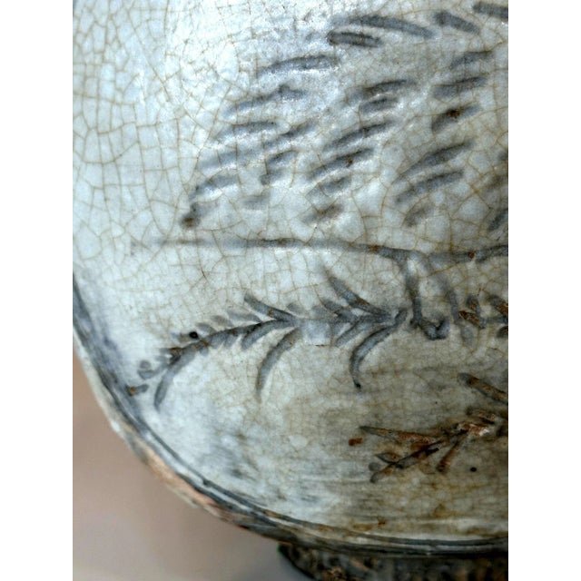 A Korean Buncheong stoneware vase circa 15th century of Joseon Dynasty. The robust vase with thick walls was made in a...