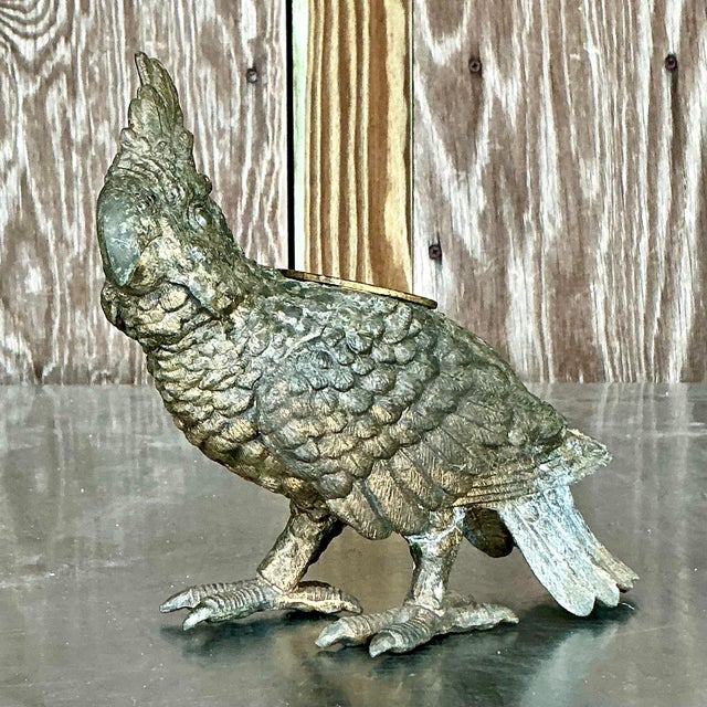 This charming vintage candle holder features a beautifully detailed parrot cast in metal, showcasing a rich, patinated...