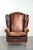 This comfortable English-style cowhide wing armchair features a beautiful warm color scheme and a characterful appearance....