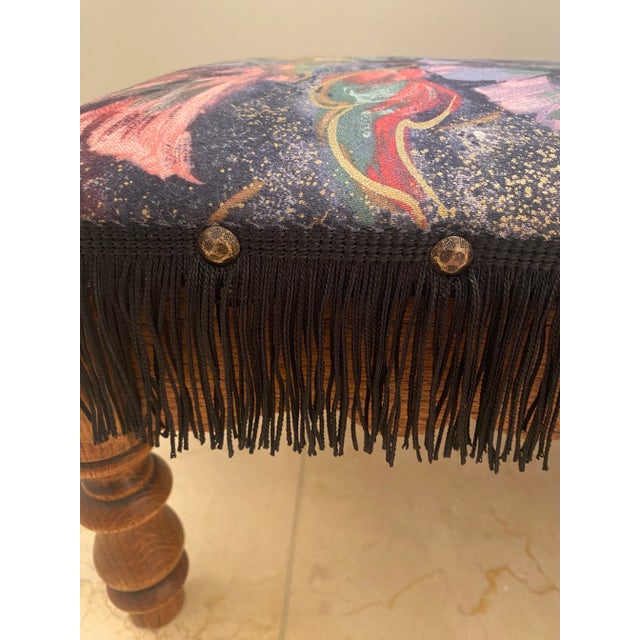 Adorable heavyweight antique wood footstool with a bright moody abstract floral fabric. Most likely recovered in the 80s....