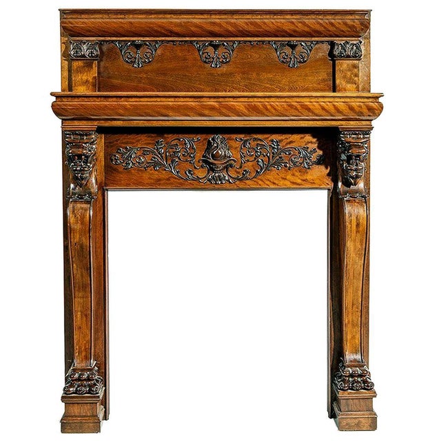 A large and impressive mahogany fireplace mantel with carvings. The piece is of American origin, circa late 19th century...