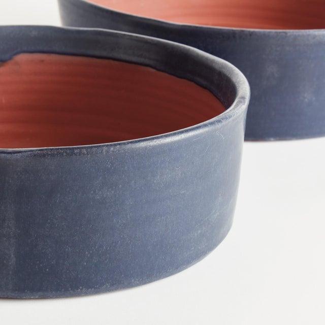 With a crackled glaze, uneven texture and basic form, this set of terracotta low bowls is simple and raw. In an ontrend...