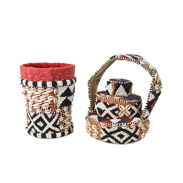 The Kuba Basket Royal Beaded Raffia with Shells is a traditional craft originating from the Kuba Kingdom, now situated in...