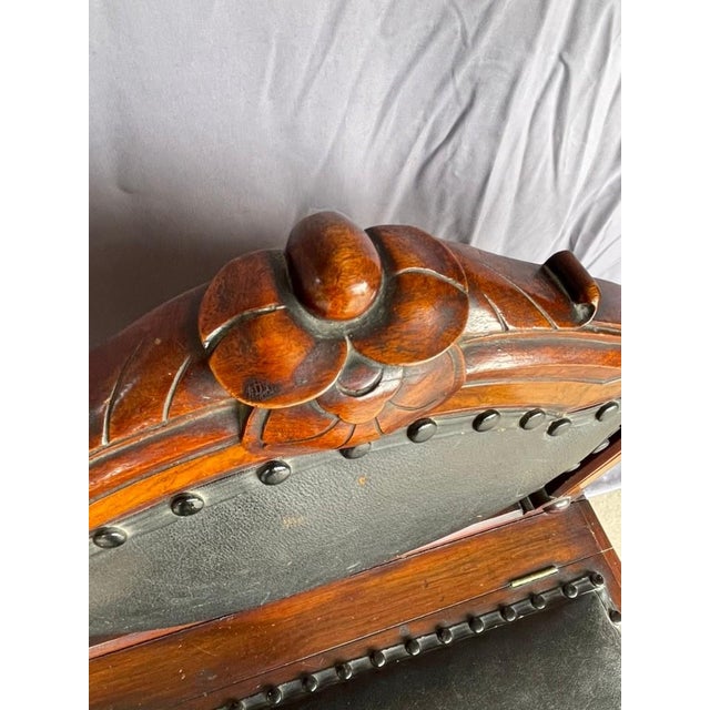 Pair of 19th century low hall chairs in the ecclesiastical bishop-style manner: intricate floral and dial-motif carving,...