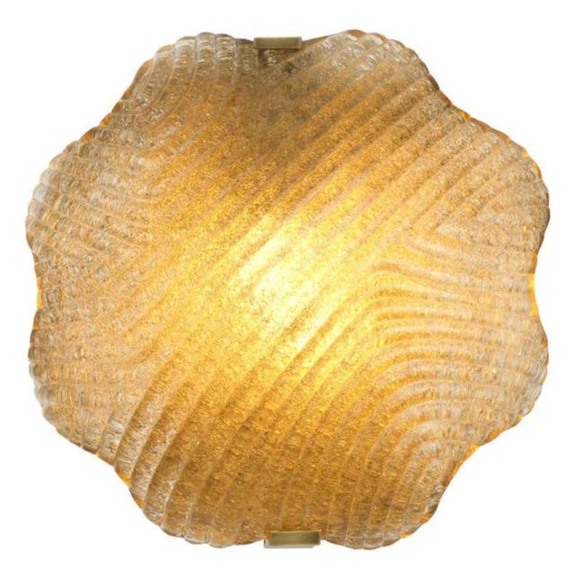 Pair of wall lamp made with handmade textured glass and a vintage brass finish, combining a softly sculptural form with...