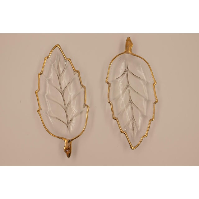 Clear pressed glass molded in a naturalistic leaf form — central rib and lateral veining pressed into the surface,...