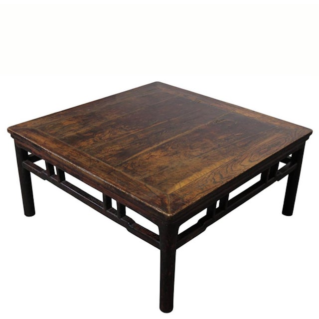 This antique square table features a low-profile design traditionally used on elevated living platforms. Constructed from...