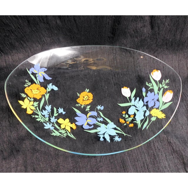 This is a a kind of oval shaped, clear glass serving tray by Heinrich & Co. in the Primavera pattern from 1977. The tray...