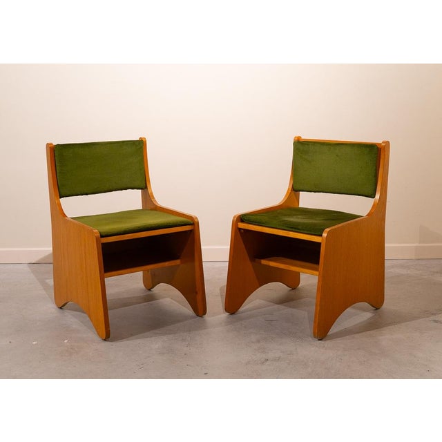 Set of Spanish Mid-Century chairs from the 1960s, made of wood. The chairs rest on two large side panels that support the...