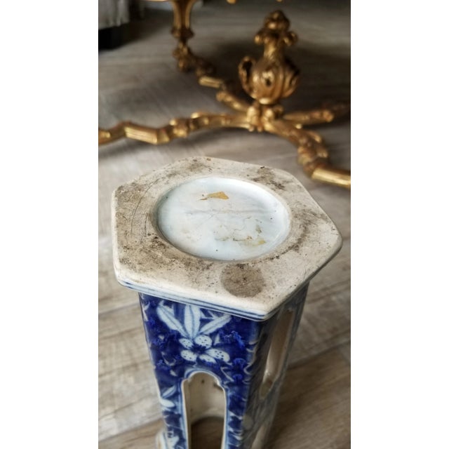 Unusual blue and white Asian wig stand vessel with blue hand painted details and glazed surface. I'm guessing that it is...