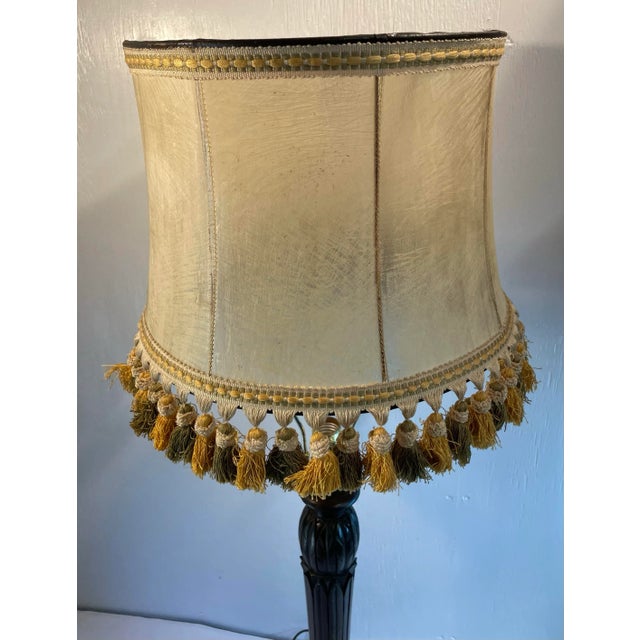 English vintage stretched leather lamp shade with tassels on the rim.