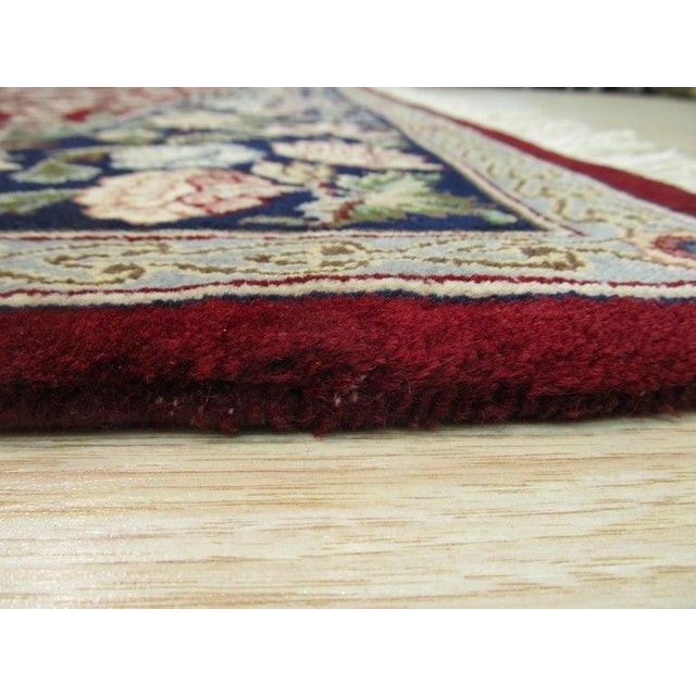 This red and rust area rug is a hand knotted pile carpet crafted from wool. It represents a classic example of Kazak style...