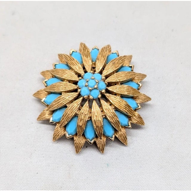 1960s textured goldtone round and marquise faux-turquoise brooch with security clasp. Marked "© PANETTA" on the back....