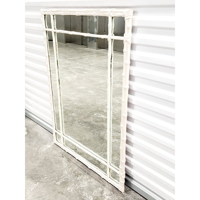 Mid Century Hollywood Regency style painted faux bamboo mirror, in a mother of pearl finish. The gorgeous mirrored can be...