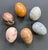 A beautiful set of Italian polished stone eggs featuring a variety of stones: Rhodonite-pink and black Jasper-orange...