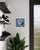This vibrant oil painting features an inflatable flamingo, rendered in bold pinks and deep blacks, creating a striking...