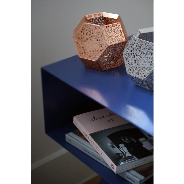 The Robot side table features an open shelf on zig zag legs. A minimal design made in solid steel, powder coated in...