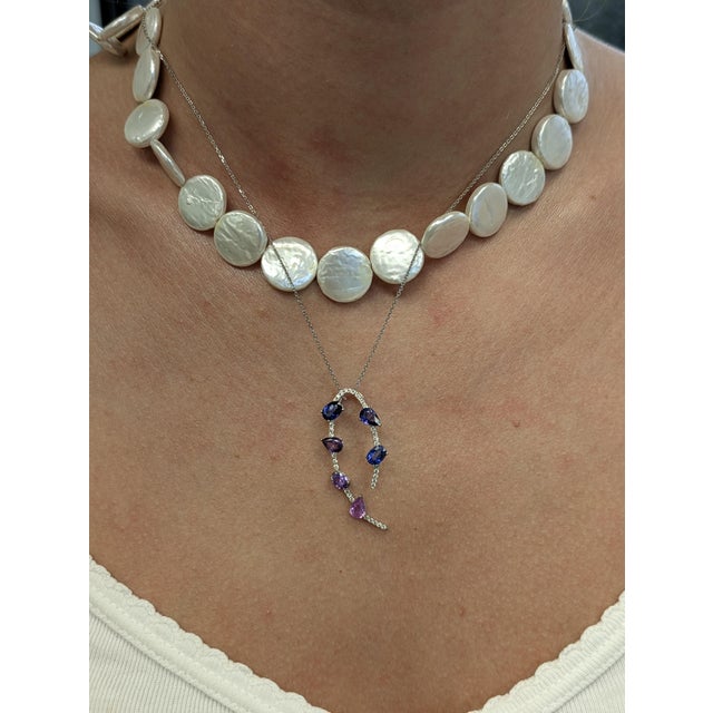 Graceful and eye-catching, this pendant features six sapphires in a striking ombré of violet and purple tones, accented by...