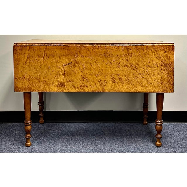 Exceptional antique circa 1820-1830 Sheraton drop leaf table. The table is made of solid Birds Eye maple with an...