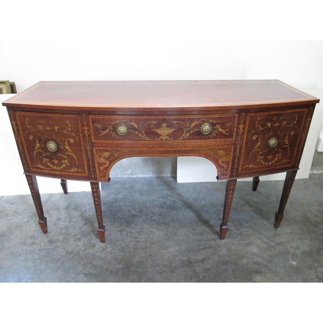 This is a wonderful heavily inlay Adams style sideboard. The origin is English, please note the inlays of dragons, urns,...
