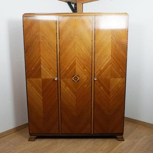 An Art Deco wardrobe with intricate satinwood and ebonised inlay. Figured walnut veneered with macassar ebony base....