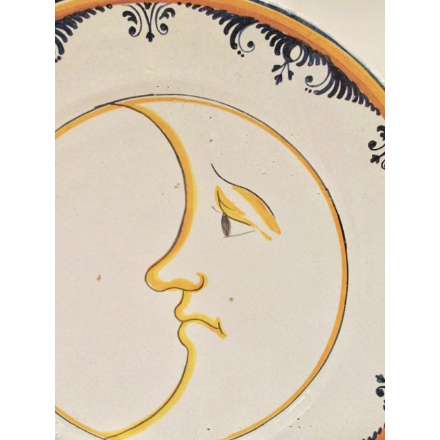 Wide and deep french faience wall decoration. Provincial cream glaze over a red clay body. Face of sun as central...