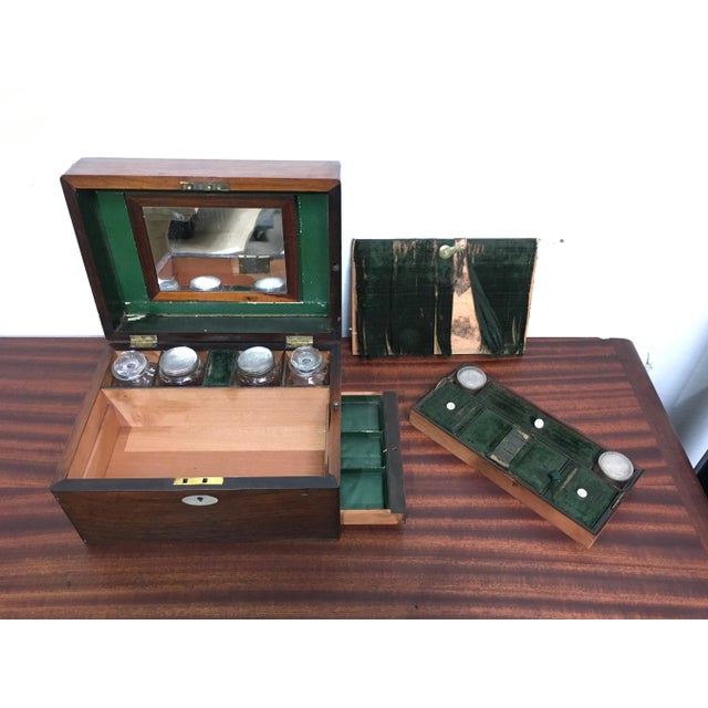 Wonderful gentleman's dressing table set in gorgeous Rosewood box with mother of pearl accents. Four larger cut glass...