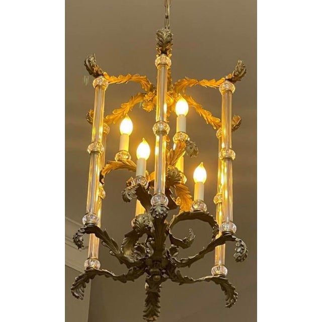 Ornate brass chandelier with glass pillars. Solid brass ceiling canopy, this fixture was supported from a 2x4 stud. Weighs...