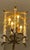 Ornate brass chandelier with glass pillars. Solid brass ceiling canopy, this fixture was supported from a 2x4 stud. Weighs...