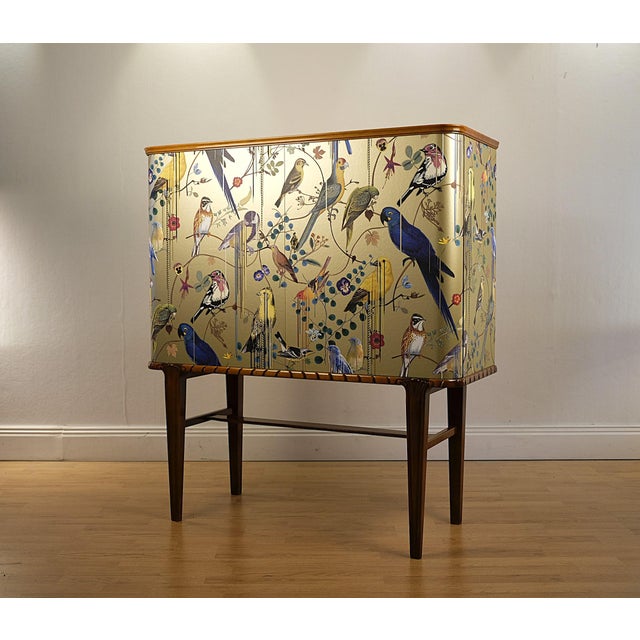 Striking Swedish Modern cabinet, ca 1940-50s, professionally reimagined with Christian Lacroix Design Wallpaper in gold. A...