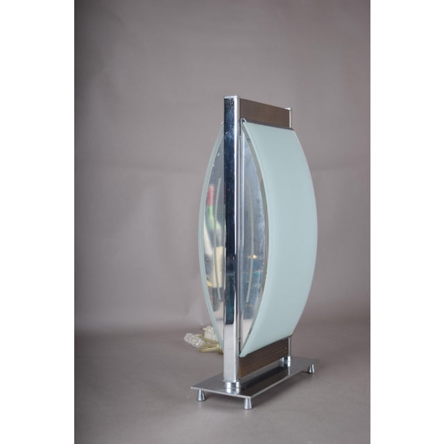 Sculptural vintage table lamp with a curved frosted-glass front panel and mirrored glass panel behind, framed by slim...