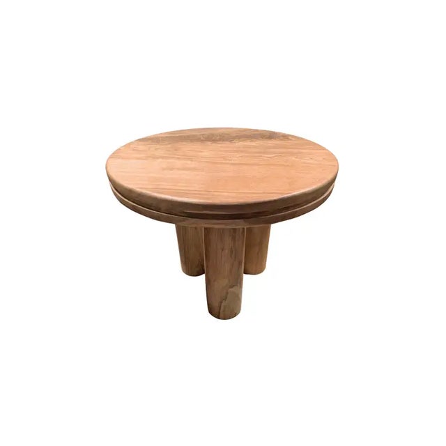 A wonderfully sculptural round side table. Crafted from solid teak wood the table top features a carved channel that wraps...