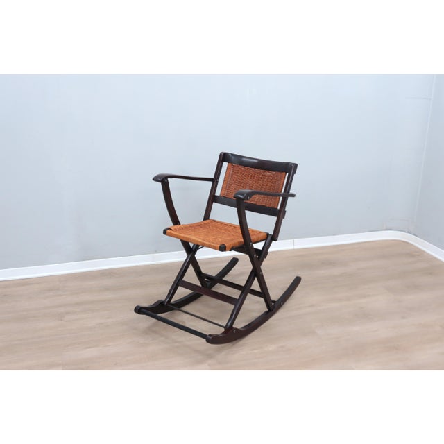 A masterpiece of elegance and functionality, this rare folding rocking chair, crafted by the renowned italian manufacturer...