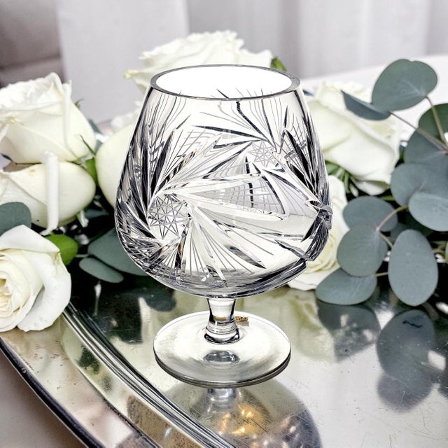 A late 20th-century West German hand-cut lead crystal vessel, executed in a bold oversized snifter form and distinguished...
