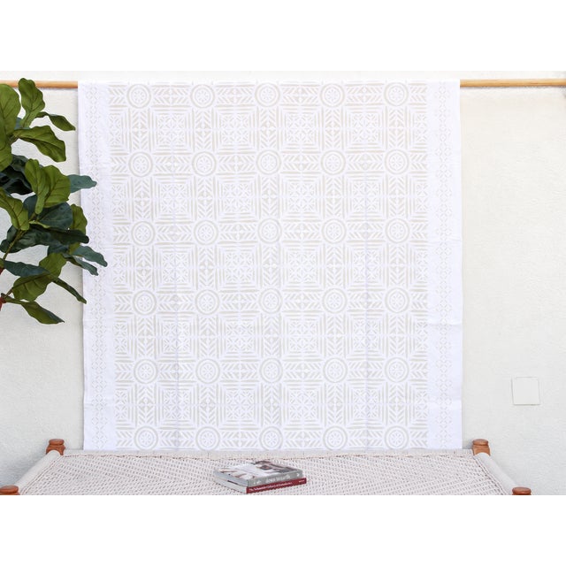 A lightweight cotton coverlet from Western India, beautifully adorned with intricate handcrafted appliqué cutwork. The...