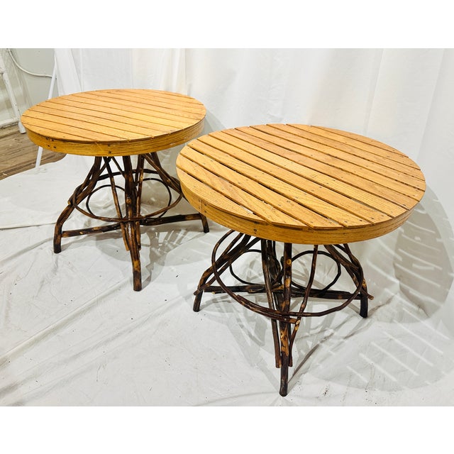 A charming pair of Adirondack-inspired twig side tables featuring handcrafted bentwood bases and slatted oak tops. The...