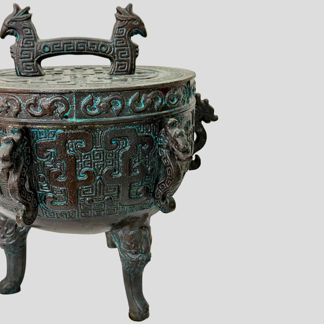 Striking vintage Chinese archaic-style tripod ice bucket dating to the Mid-Century era, circa 1960s. Designed in the...