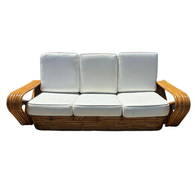 Mid-century six-strand 3-seat rattan sofa features square pretzel arms and a classic stacked base. Made of steam-bent...