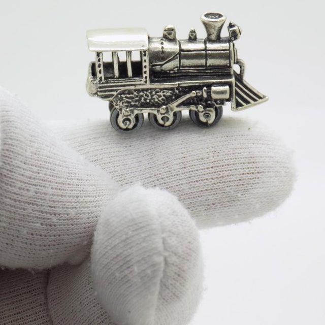 A vintage miniature depicting a railway locomotive, handcrafted in Sterling Silver (925/000) in Italy between the 1970s...