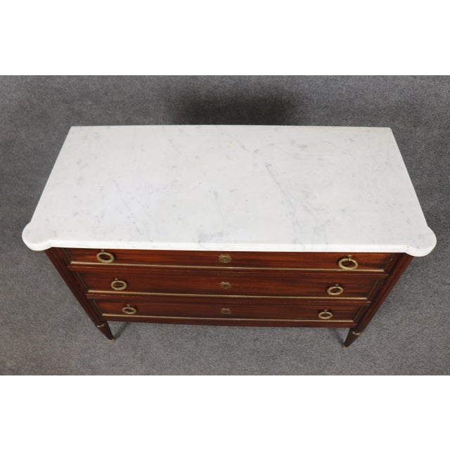 An elegant and classically proportioned French Louis XVI Directoire style commode, distinguished by its refined...