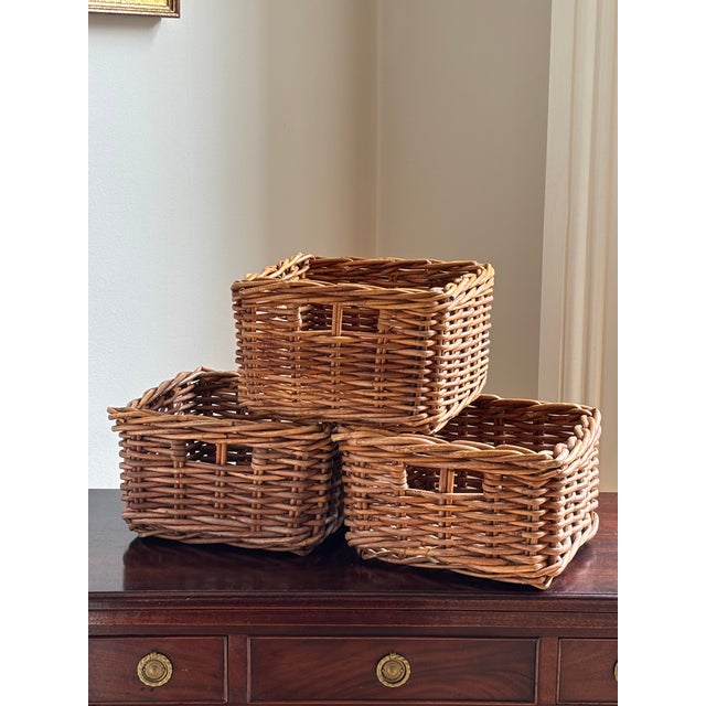 Offering a set of three small wicker storage baskets from the late-20th century. Love their French randing, warm patina,...