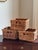 Offering a set of three small wicker storage baskets from the late-20th century. Love their French randing, warm patina,...