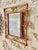 French Riviera bamboo and rattan mirror with scrolling detail around the frame. Mediterranean, circa 1960s. This...